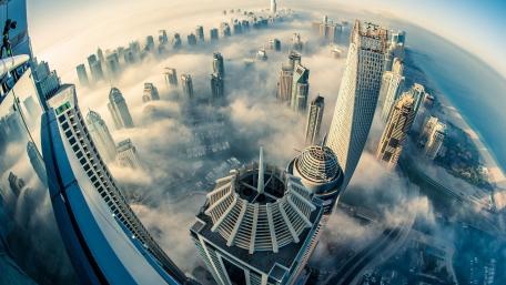 Dubai Skyline Surrounded by Misty Clouds wallpaper