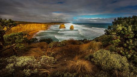 Serene Coastal Landscape with Rolling Waves and Cliffs wallpaper