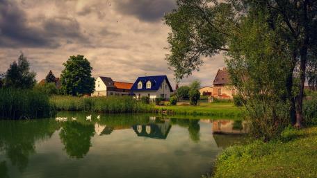 Serene Village by the Tranquil Lake wallpaper