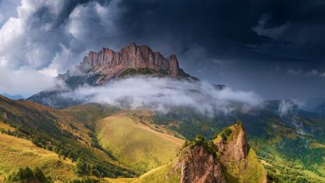 Majestic Mountain Under Dramatic Clouds wallpaper