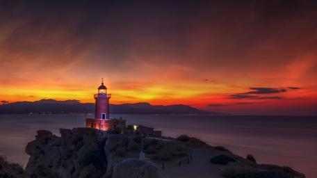 Burning Sunset Over Aegean Lighthouse wallpaper