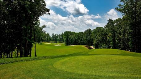 Lush Green Golf Course Under Bright Blue Sky wallpaper