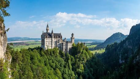 Majestic Neuschwanstein Castle Nestled in Bavaria's Lush Landscapes wallpaper