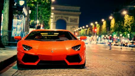 Sleek Red Lamborghini on City Streets at Night wallpaper