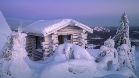 Cozy Winter Cabin in Snowy Landscape wallpaper