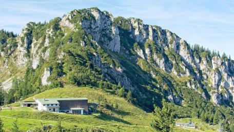 Majestic Mountain Landscape with Serene Building in Nature wallpaper
