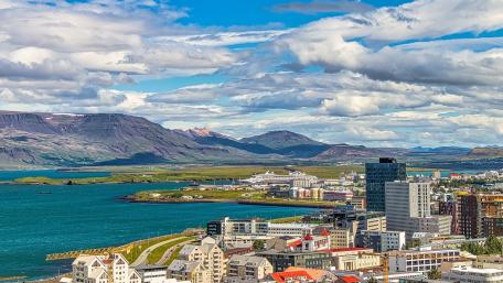 Stunning Cityscape Overlooking the Ocean and Mountains wallpaper