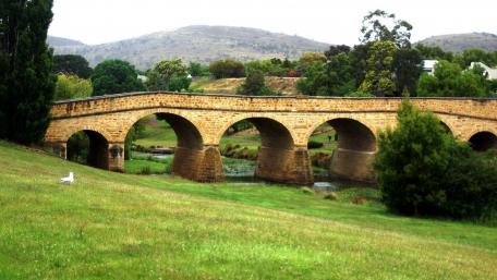 Tranquil Nature Scene with Historic Bridge wallpaper