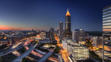 Cityscape at Dusk with Illuminated Skyline and Traffic Trails wallpaper