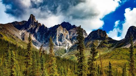 Majestic Mountains Beneath Dramatic Skies wallpaper