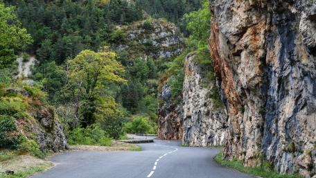 Winding Road Through Scenic Cliffs Facing Nature's Beauty wallpaper