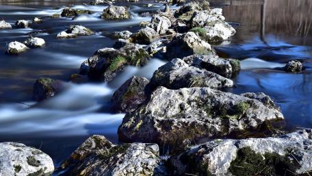 Serene River Flow with Majestic Boulders wallpaper