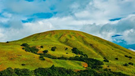 Lush Green Hills Under a Vast Sky wallpaper