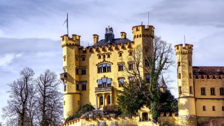 Majestic Yellow Castle Under Dramatic Sky wallpaper