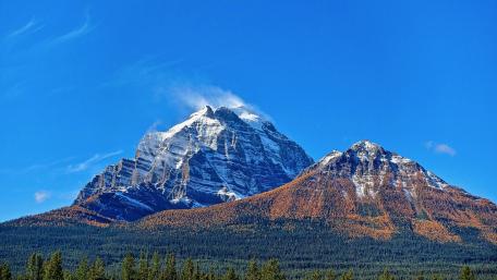 Majestic Mountain Peaks Against a Clear Blue Sky wallpaper