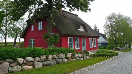 Charming Red Cottage Surrounded by Nature wallpaper