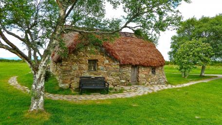 Charming Cottage Amidst a Scenic Field wallpaper