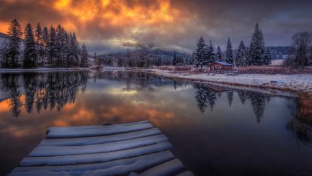 Serene Winter Reflection Over a Snowy Lake wallpaper