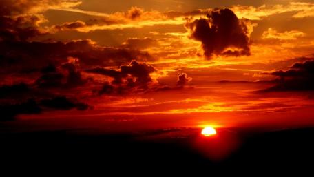 Fiery Sunset Over Calm Horizon wallpaper