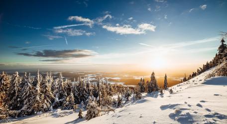 Breathtaking Winter Sunrise Over Snow-Covered Landscape wallpaper