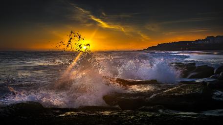 Sunset Splendor Over Waves Rising wallpaper