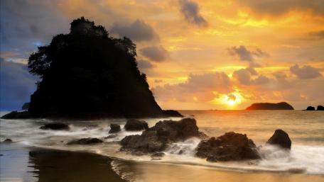 Serene Sunset Over Rocky Beach Landscape wallpaper
