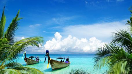 Tropical Serenity with Boats on Blue Water wallpaper