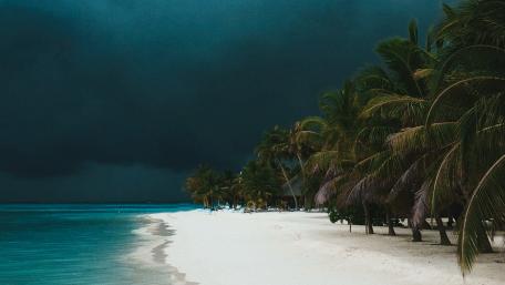 Twilight Beach Under Stormy Clouds wallpaper