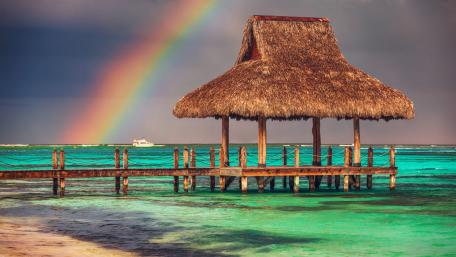 Serene Pier Under a Vibrant Rainbow wallpaper
