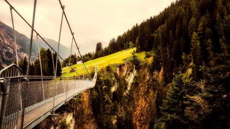 Suspension Bridge Among Lush Mountains wallpaper