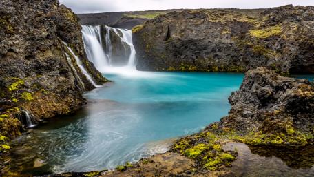 Serenity of the Blue Waterfall in Nature's Embrace wallpaper