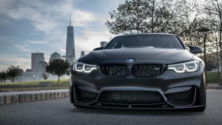 Sleek Black BMW in Cityscape Showcase wallpaper