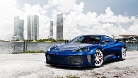 Sleek Blue Sports Car by the Water wallpaper