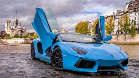 Stunning Blue Lamborghini Under Dramatic Sky wallpaper