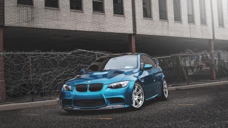 Sleek Blue BMW Dominates Urban Landscape wallpaper
