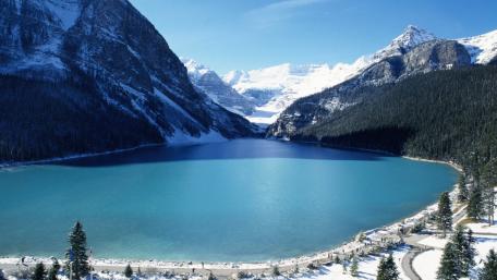 Serene Blue Lake Amidst Majestic Mountains wallpaper