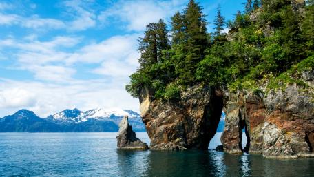 Majestic Rocky Landscape Overlooking Calm Waters wallpaper