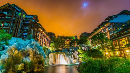 Charming Cityscape at Dusk with Waterfall View wallpaper