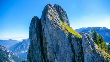 Majestic Cliff Peaks Under Radiant Sky wallpaper