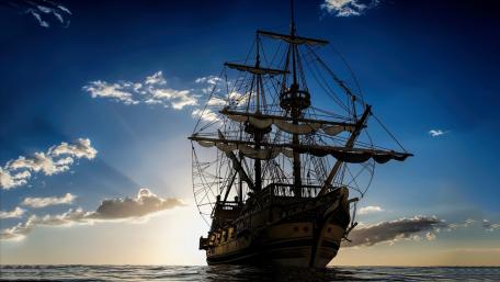 Majestic Ship Silhouetted Against a Stunning Sunset wallpaper