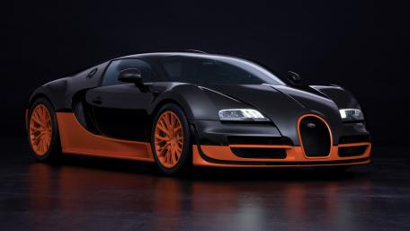 Sleek Black and Orange Supercar Wallpaper wallpaper