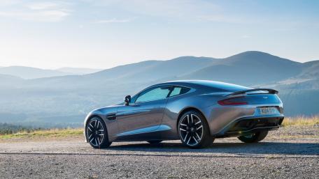 Sleek Aston Martin on a Scenic Mountain Drive wallpaper