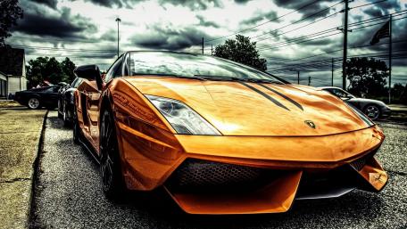 Orange Lamborghini in Dynamic Urban Setting wallpaper