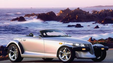 Sleek Convertible by the Ocean Shoreline wallpaper