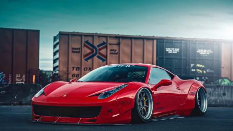 Sleek Red Ferrari in Urban Landscape wallpaper