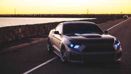 Sleek Car on a Sunset Road Scene wallpaper