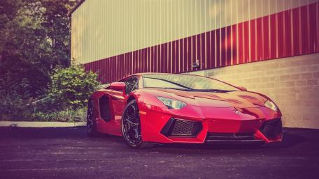Sleek Red Lamborghini in Urban Setting wallpaper