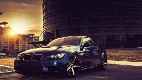 Sleek BMW Against Urban Sunset Glory wallpaper