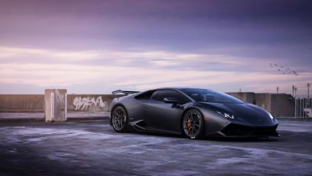 Sleek Dark Lamborghini on Rooftop at Dusk wallpaper