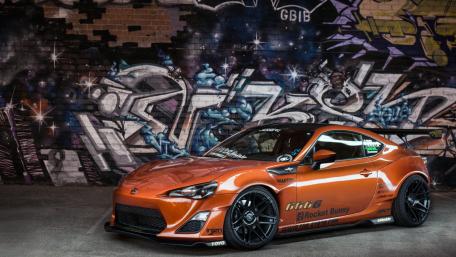 Dynamic Drift Car Against Urban Graffiti Background wallpaper
